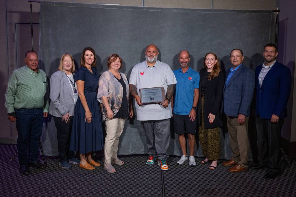 School Board Members, House Representative Kadyn Whittman, SFSD Superintendent Jamie Nold and other SFSD Administrators proudly stand next to Mark and Jesse Fonder with the Hungry Hearts organization as they hold the award for SD Community Award of the Year.
