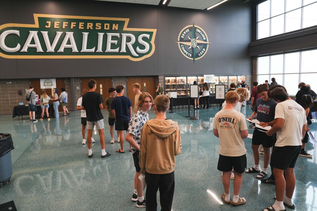 Several groups of Jefferson High School students stand in the commons area conversing and catching up at Cavalier Day on Friday, August 14, 2026. 