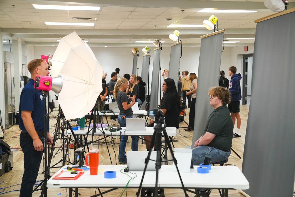A row of Jefferson High School students sit in front of a photo backdrop while posing for their school picture at Cavalier Day on Friday, August 14, 2026. 