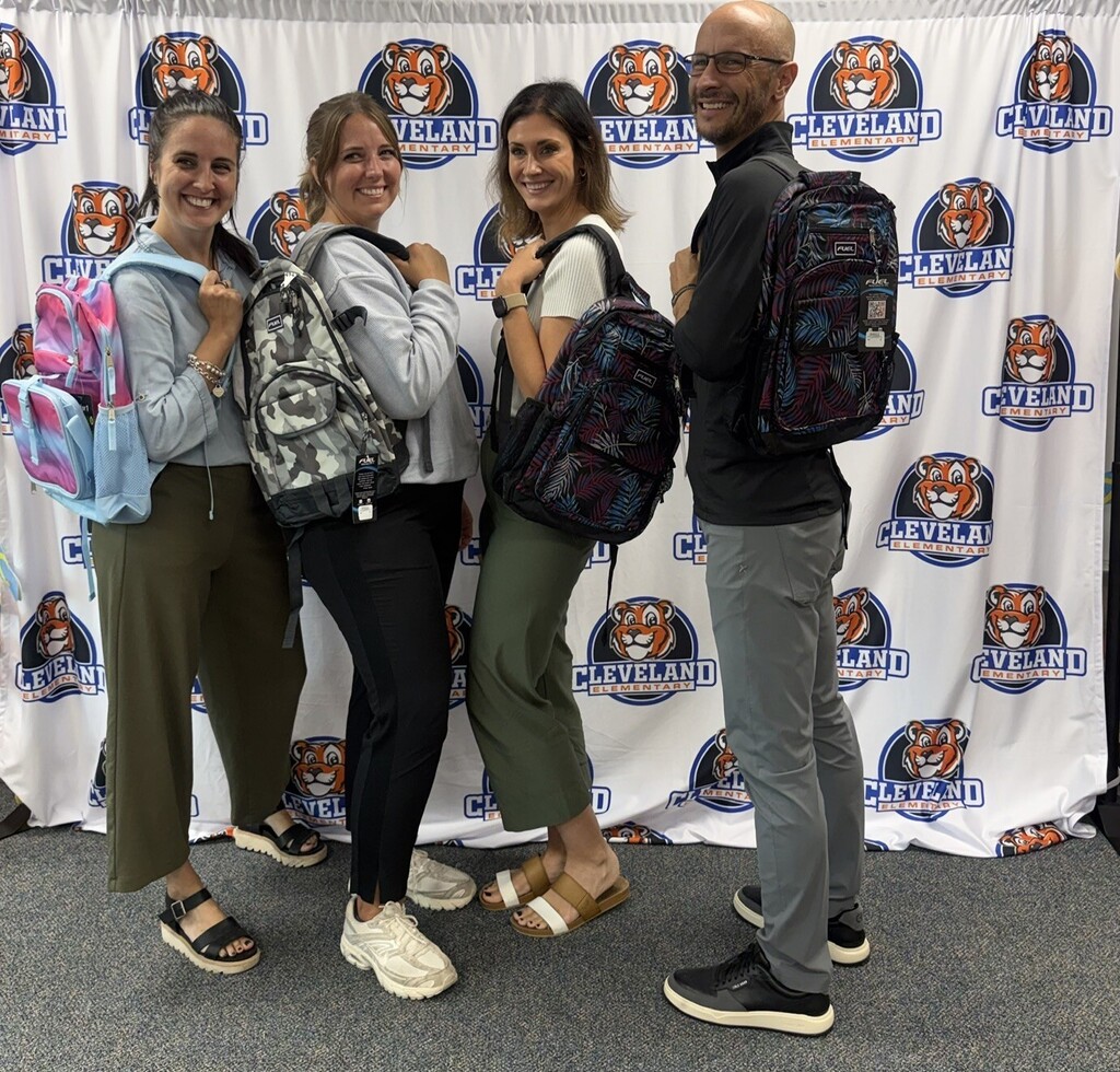 Adults displaying backpacks