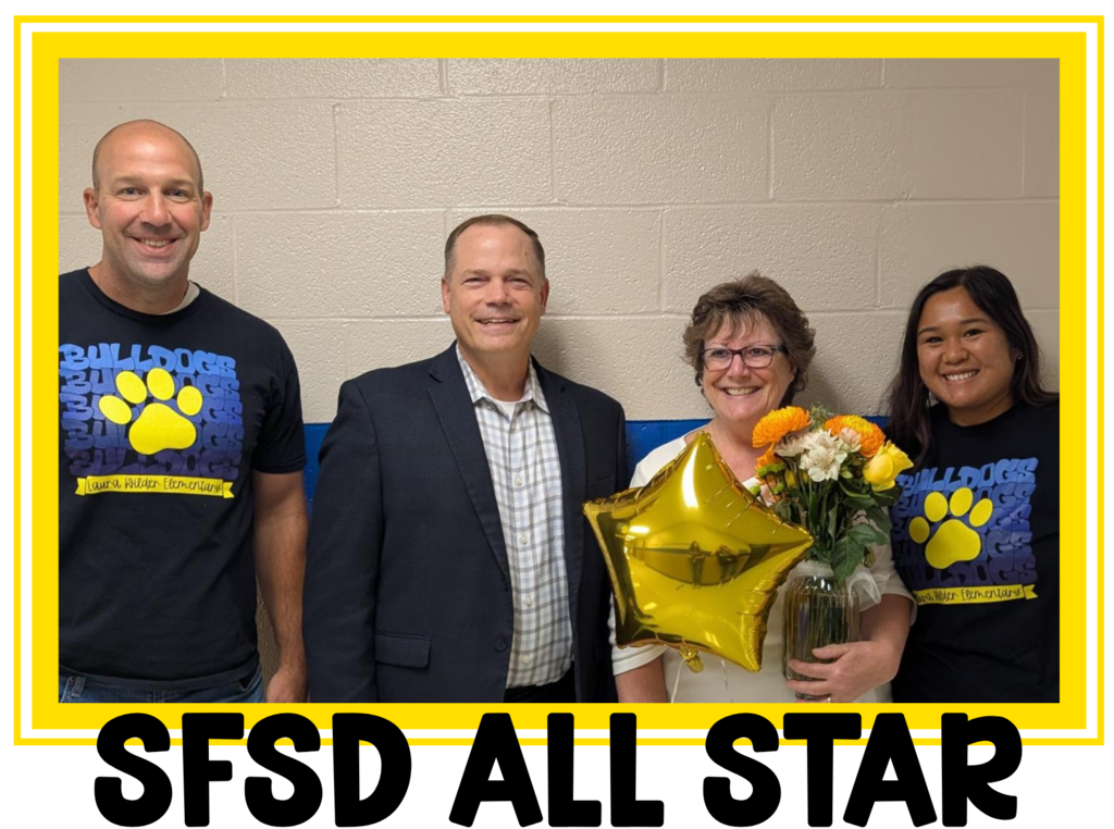 Mr. Semmler, Dr. Nold, Mrs. Ev & Mrs. Emalie pose for a picture after Mrs. Ev was nominated for being a Sioux Falls School District All Star!