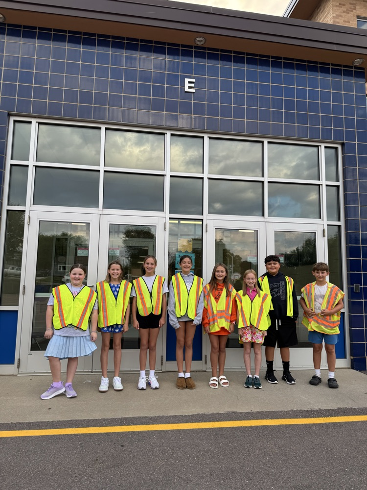 student greeters standing in front of the arrival door.