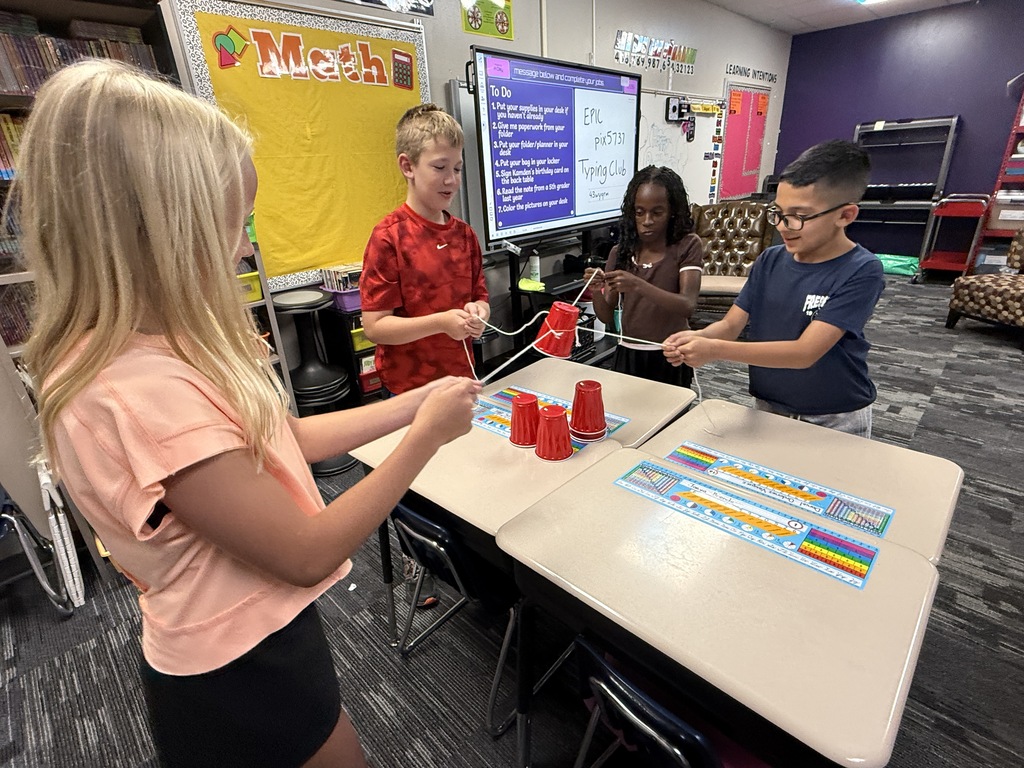 Students building a pyramid of cups. 
