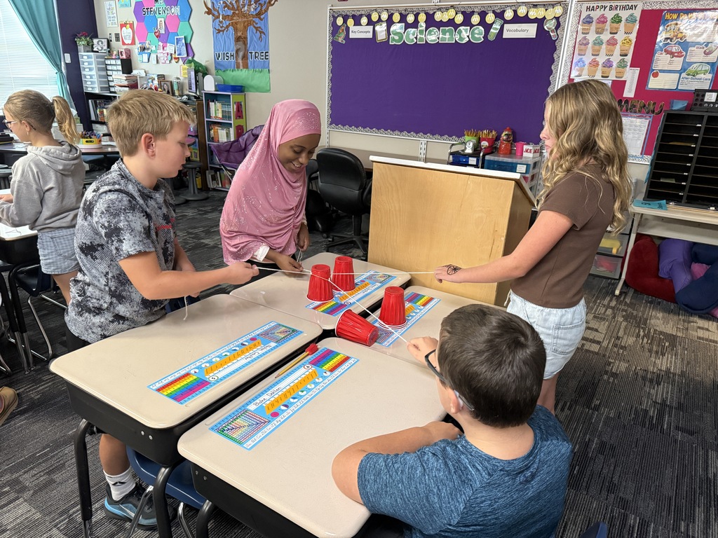 Students building a pyramid of cups. 