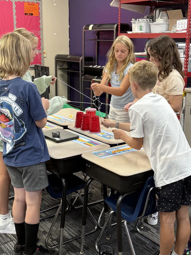 Students building a pyramid of cups. 