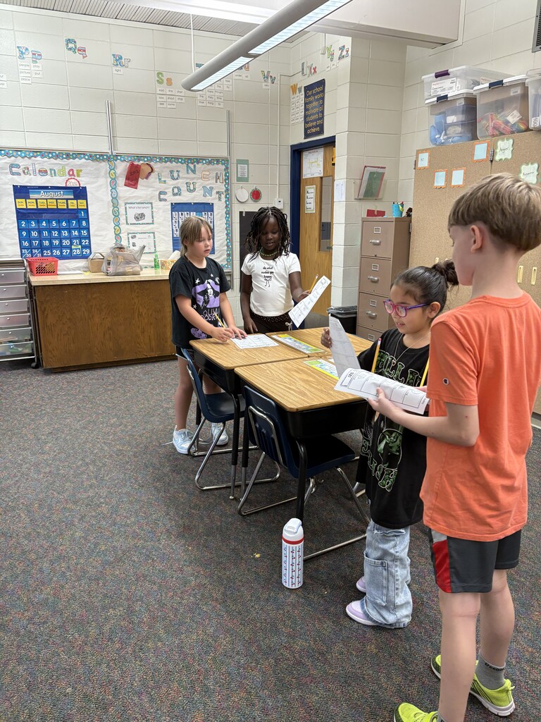 2 pairs of students talking with each other.