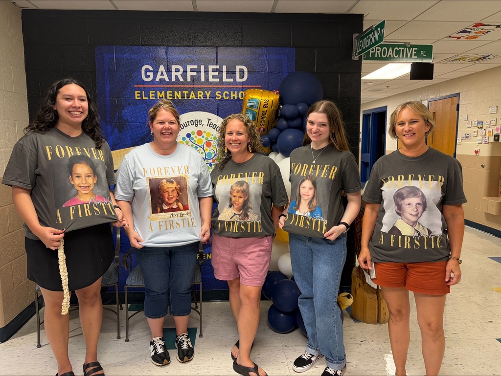 1st grade teachers wearing their pictures from 1st grade.
