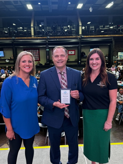Superintendent Jamie Nold joyfully stands next to two Boys and Girls Clubs of the Sioux Empire staff members after receiving the BGCSE Community Impact Award