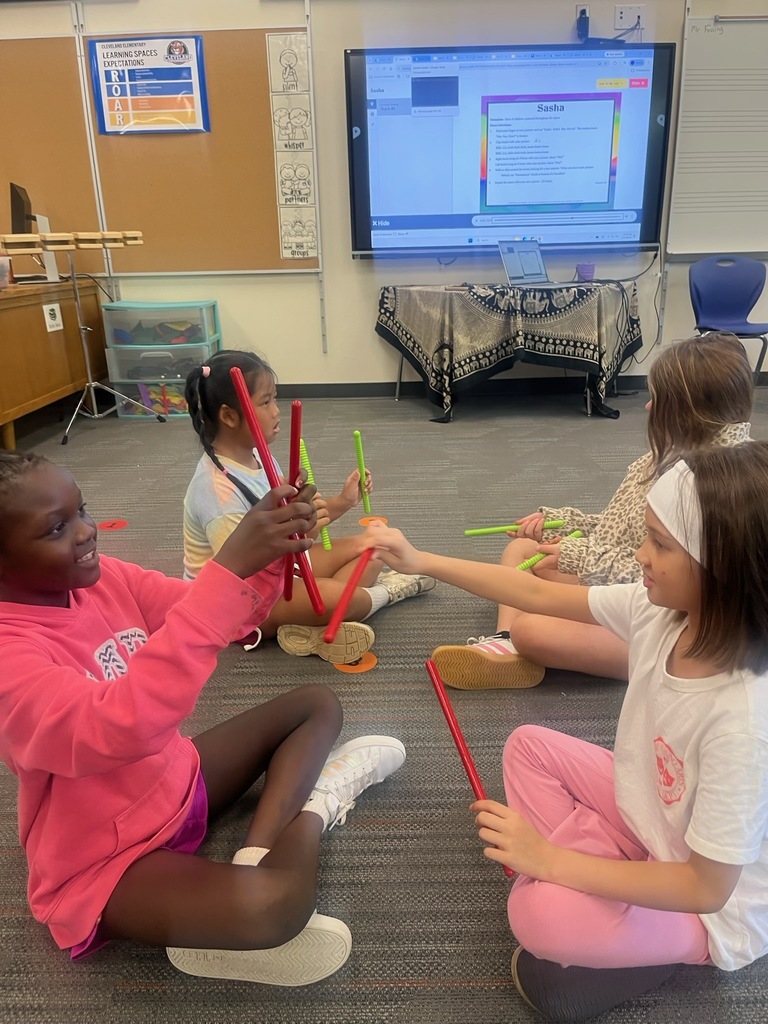 Four girls using rhythm sticks