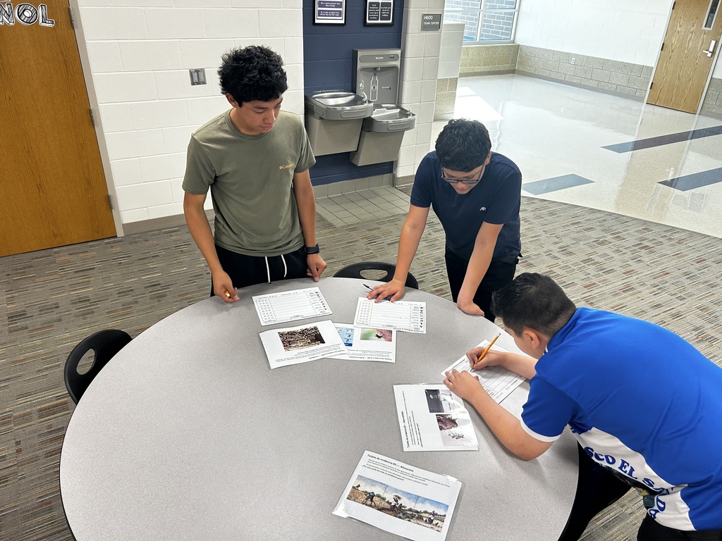 Three students participating in a gallery walk to learn more about Jamestown.