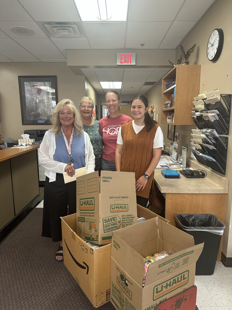 Mrs. Skogstad with 3 people from St. John’s Church donating items to the school 
