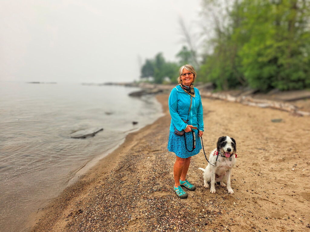 Miss Tina by the water with her dog.