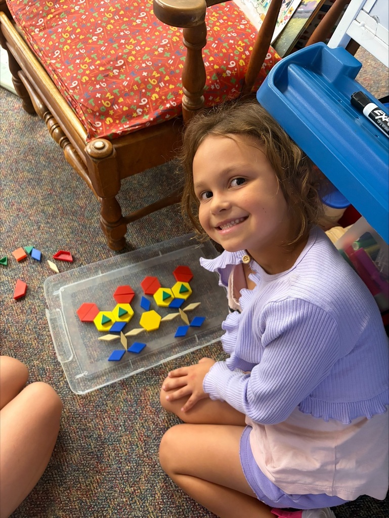 A student creating small animals out of math shapes.