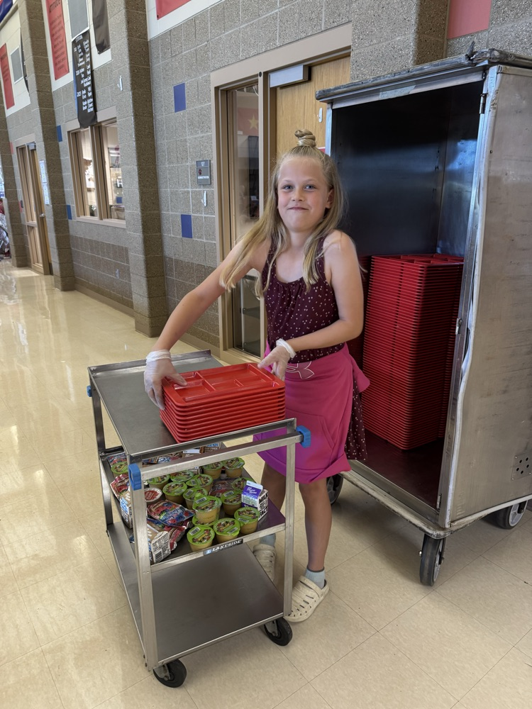a girl stacking lunch trays 