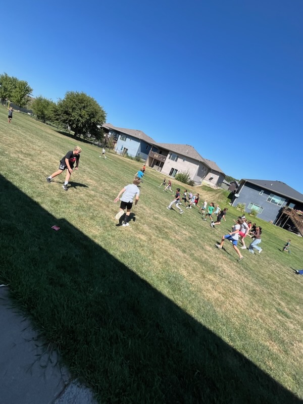 students outside running a race