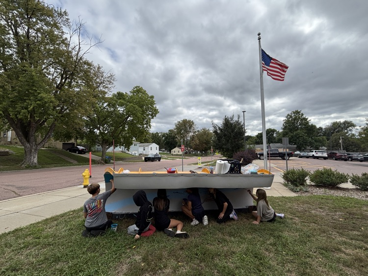 students painting the plow