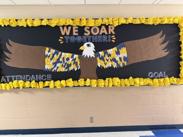 Bulletin board of the feathers being added to the eagle for attendance goals.