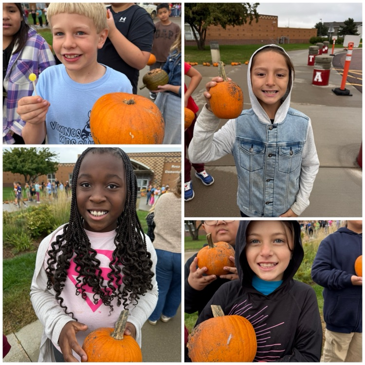students showing off their pumpkins 