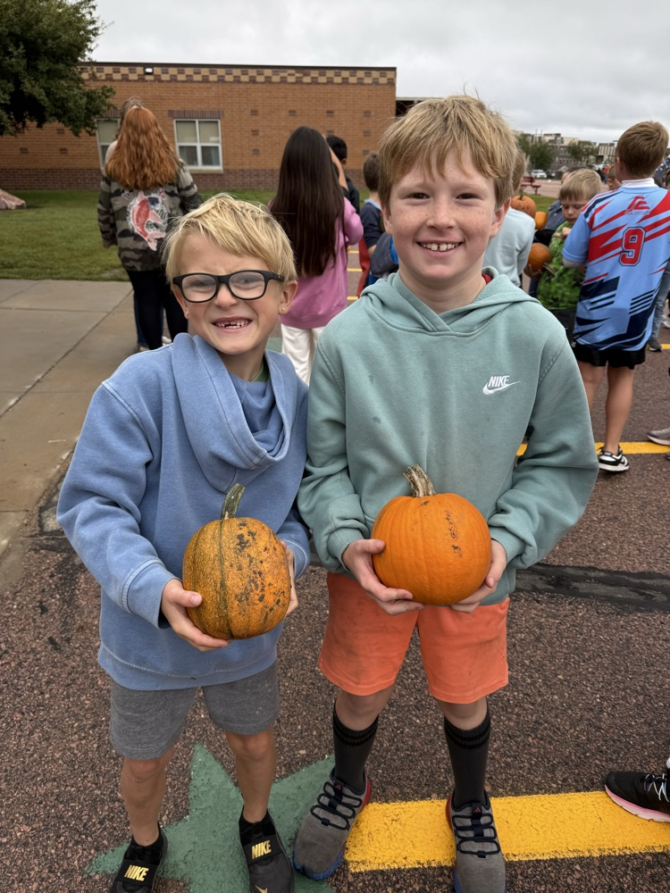 two students and their pumpkins 