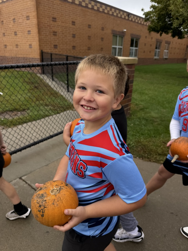 a student holding their pumpkin
