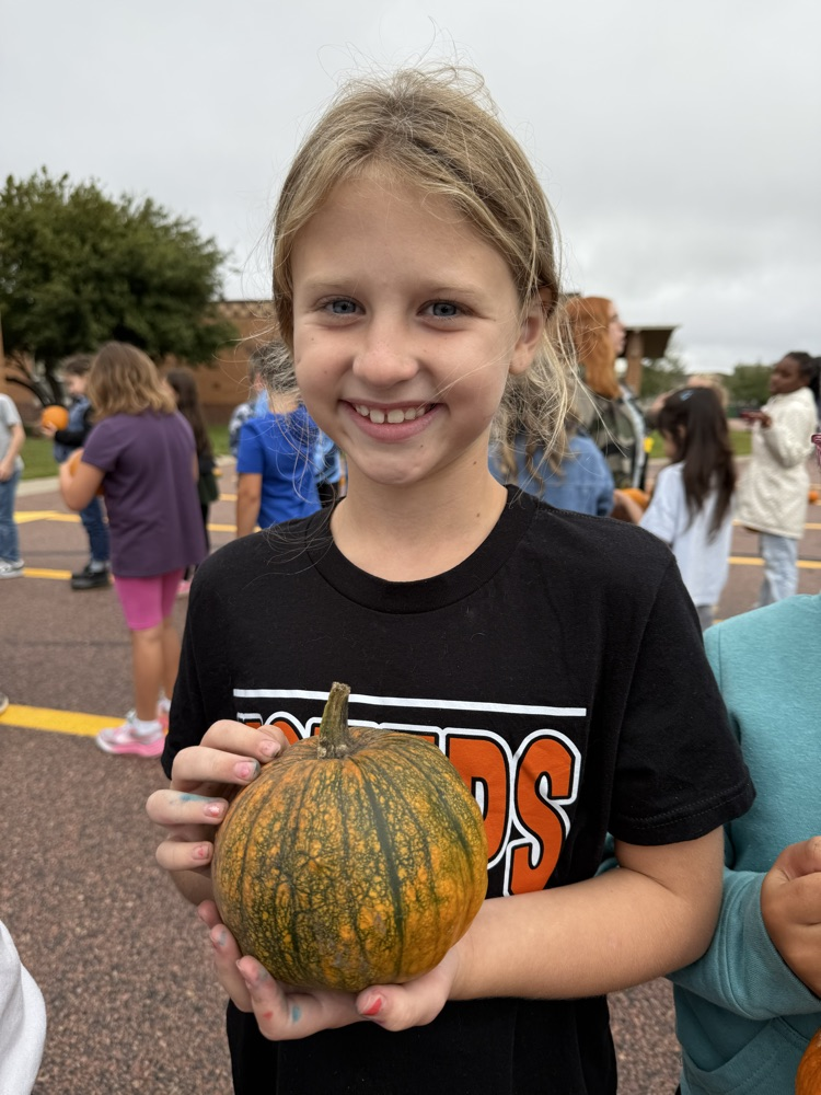 a student and their pumpkin 