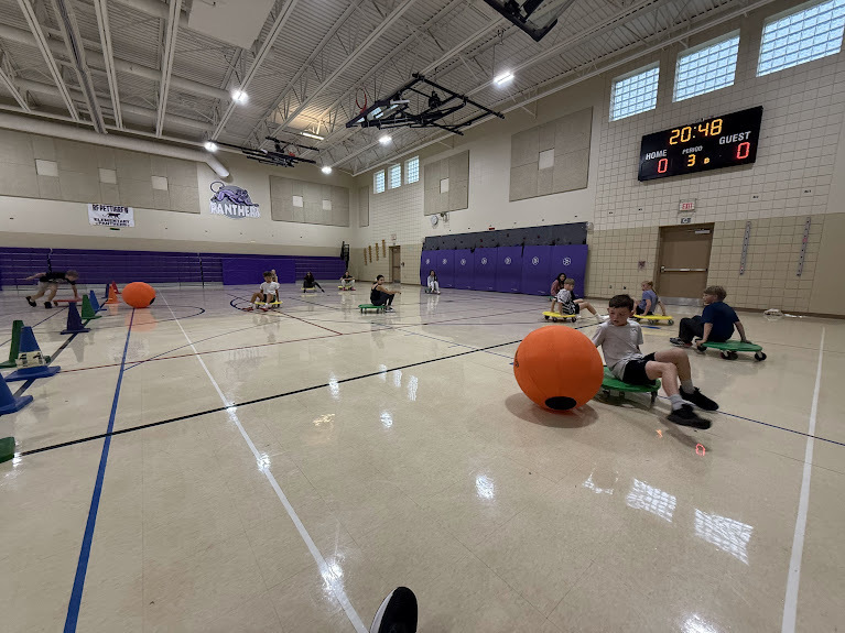 Students playing scooter game in pe
