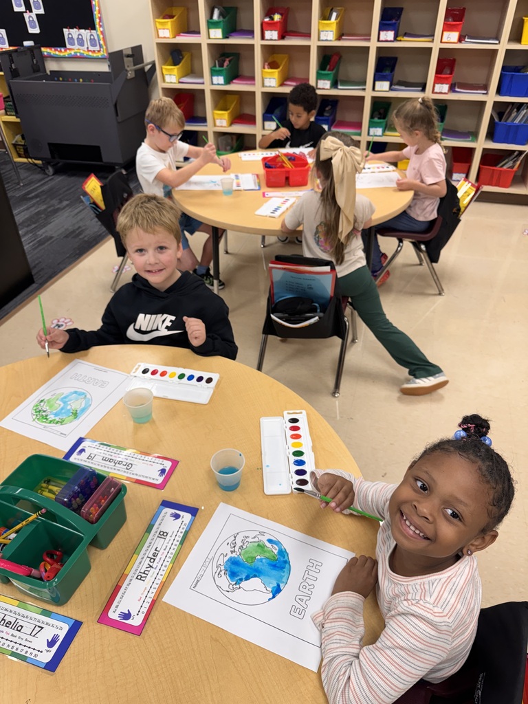 Students creating pictures of the earth 