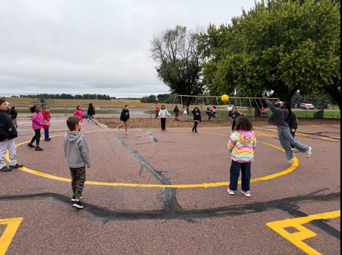 a group of students in a circle playing ball