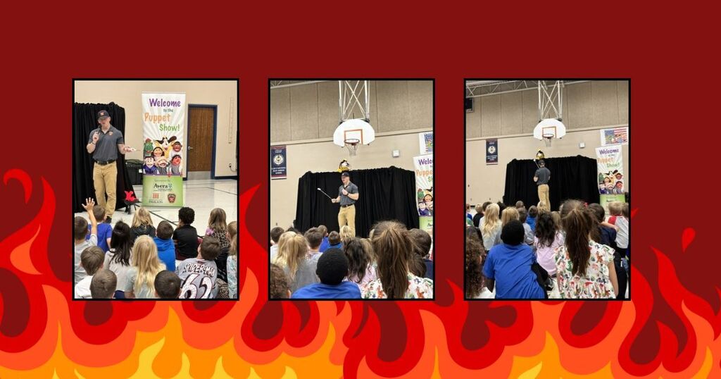 Cartoon fire, students observing puppet show with firefighter presenting