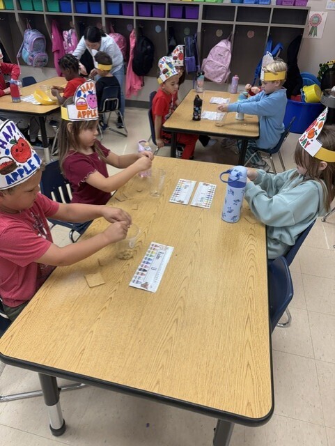 Kindergarteners making apple pie in a cup.