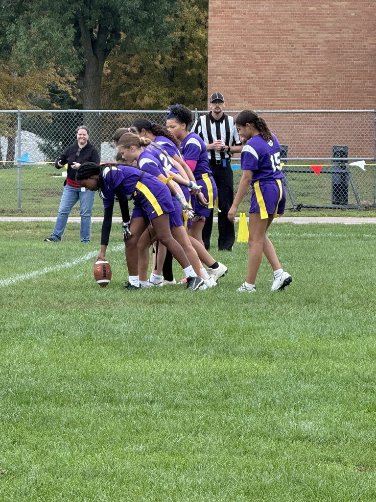 Flag football players lined up to start a game. 