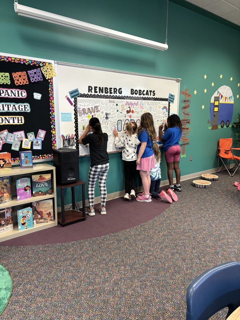 5 girls standing at the white board coloring on a sheet of paper.