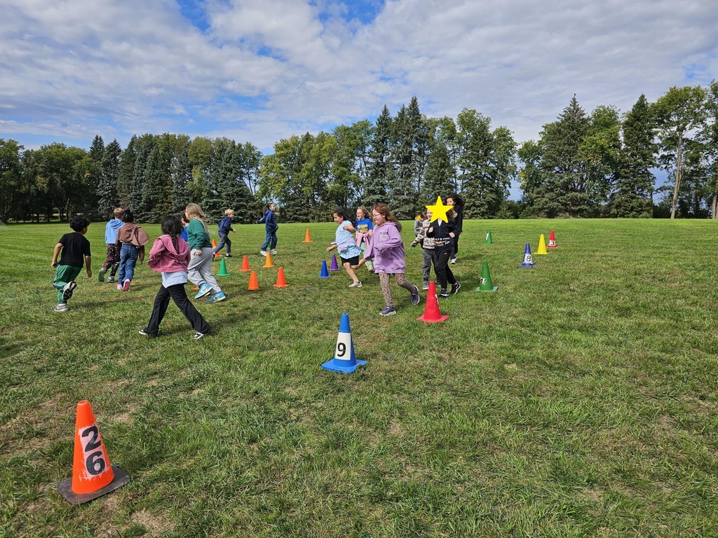 3rd grade students walking around in a circle