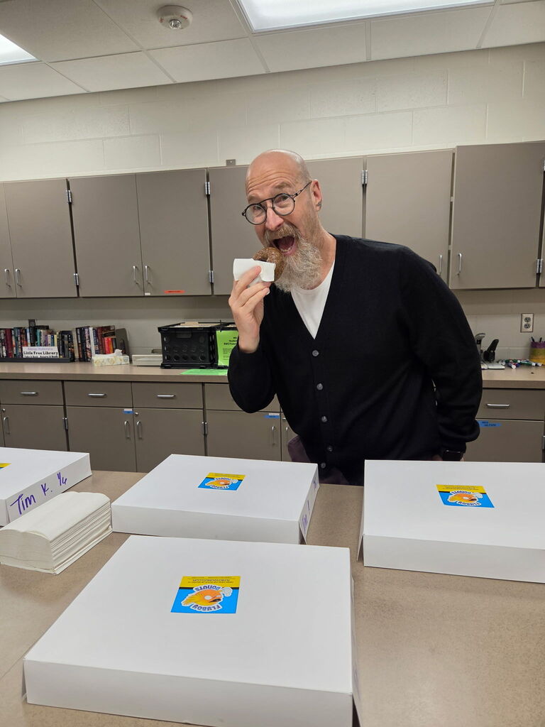 Staff eating doughnuts. 