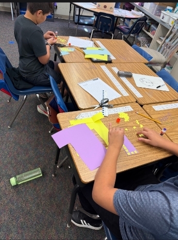 2 biys cutting and working on their arrays