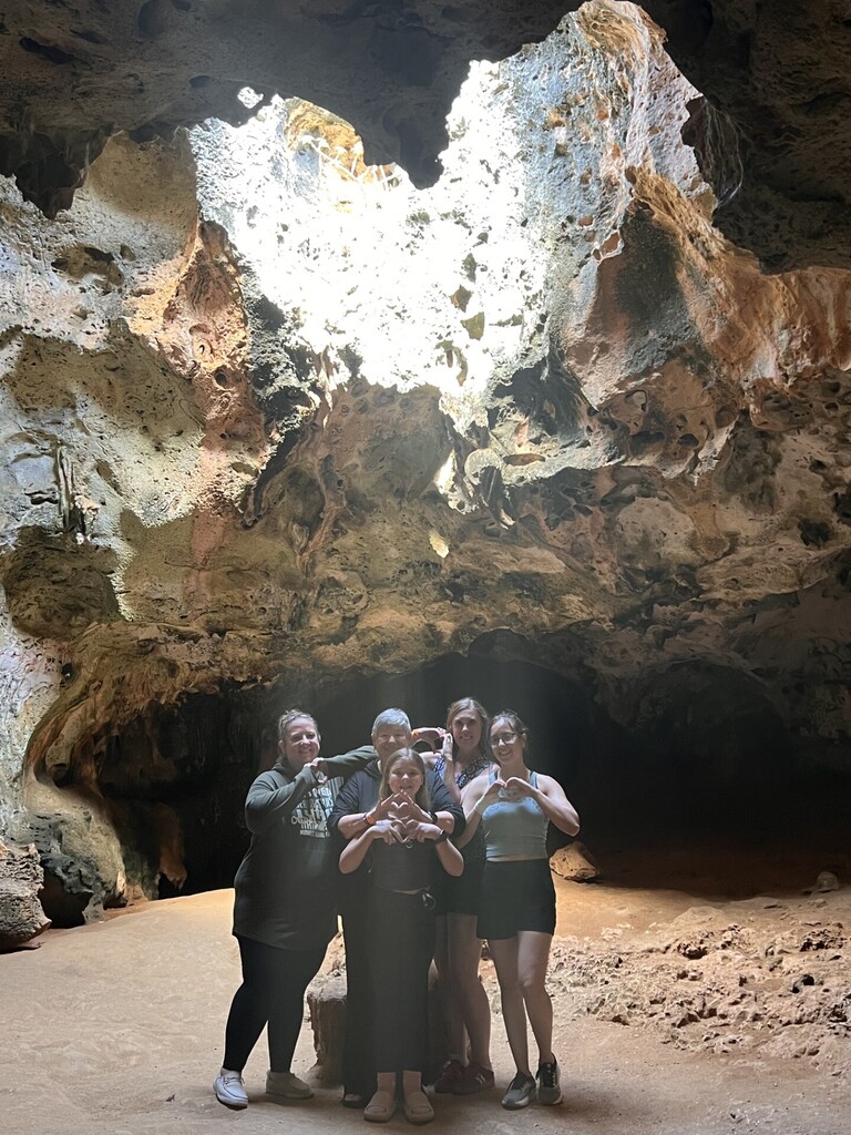 Mrs. W in a heart shaped cave with friends.