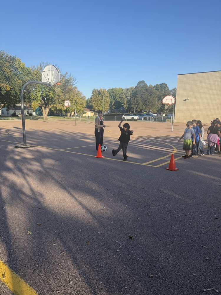 Student kicking the soccer ball