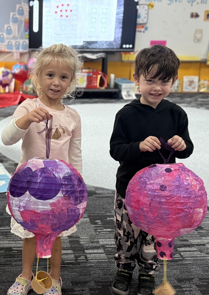 Students holding their hot air balloon project.