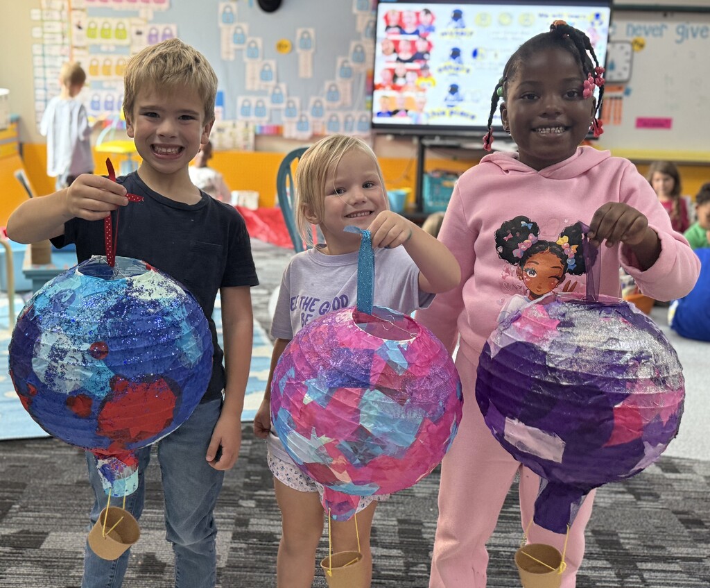 Students holding their hot air balloon project.