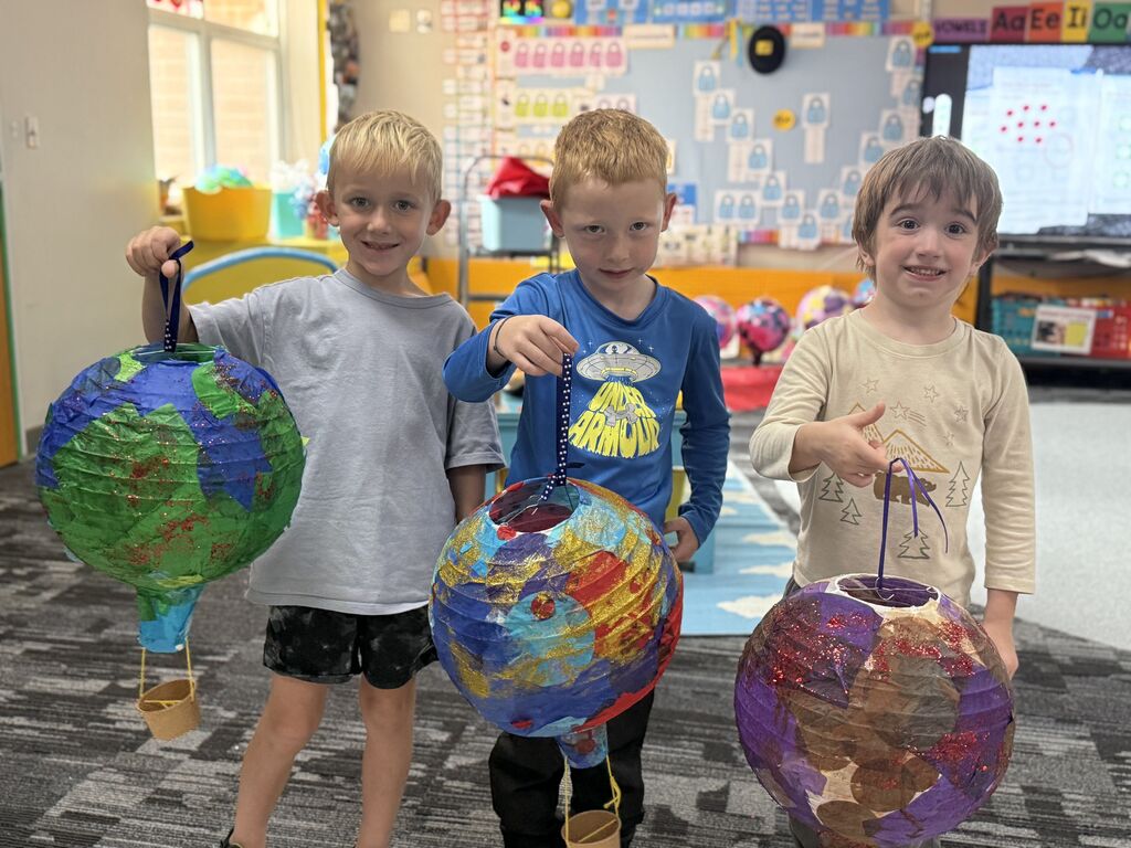 Students holding their hot air balloon project.