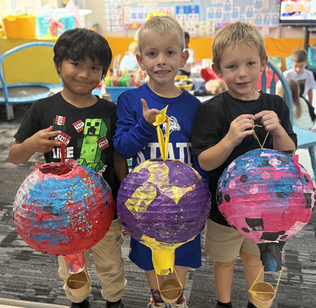 Students holding their hot air balloon project.