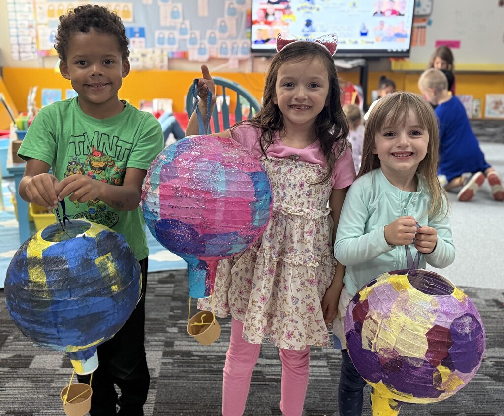 Students holding their hot air balloon project.