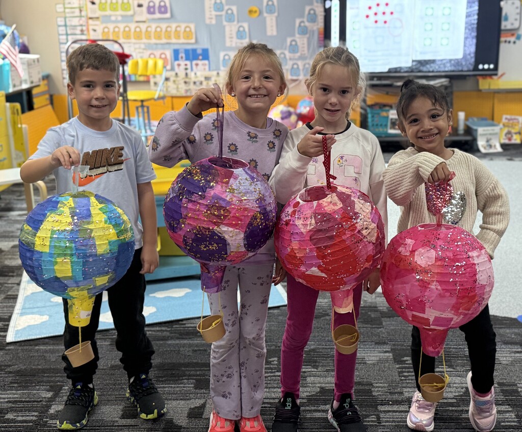 Students holding their hot air balloon project.