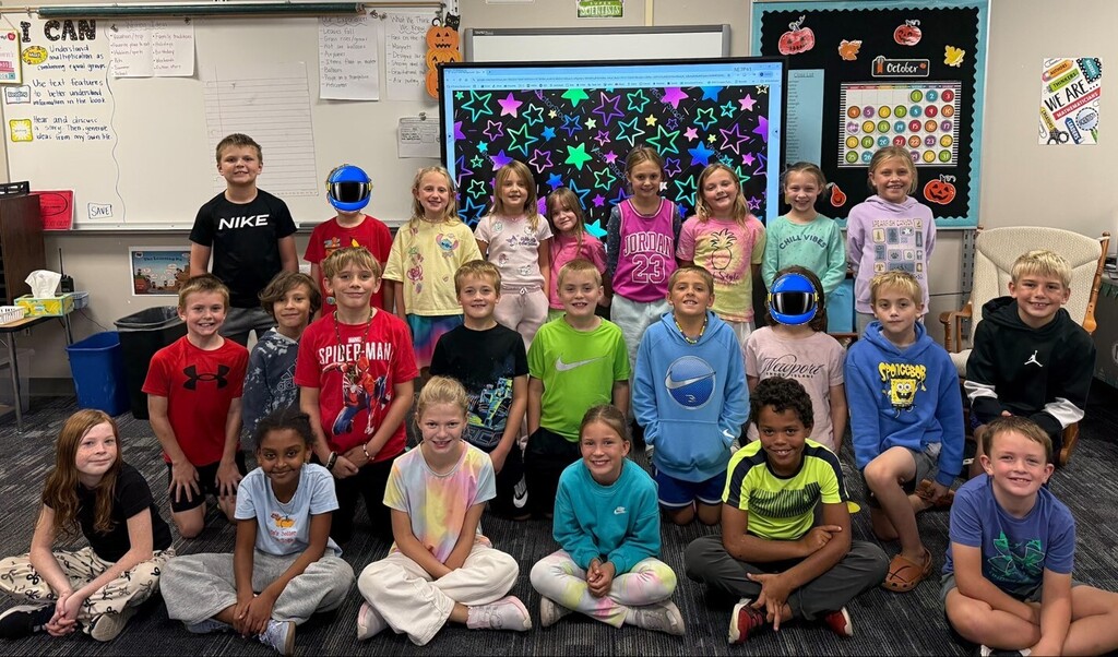 Students smiling while wearing bright neon colors to celebrate Monday's homecoming week dress up day, which was Neon Day.