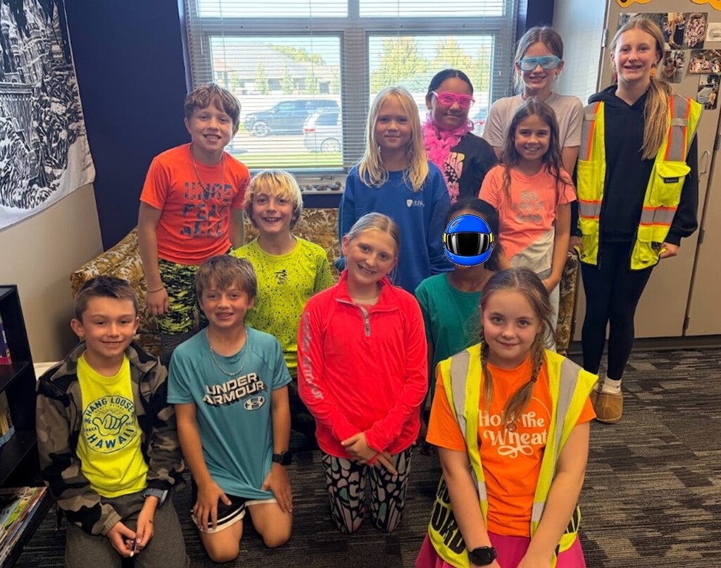 Students smiling while wearing bright neon colors to celebrate Monday's homecoming week dress up day, which was Neon Day.