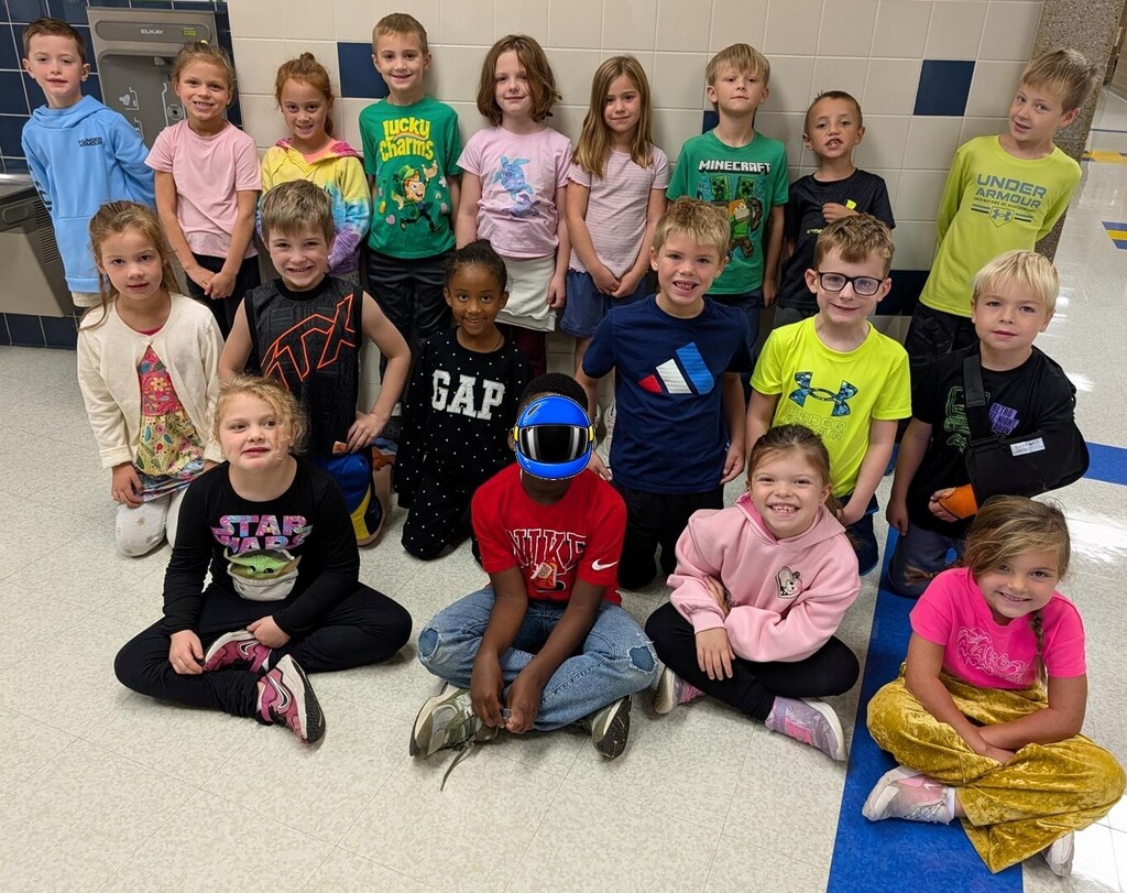 Students smiling while wearing bright neon colors to celebrate Monday's homecoming week dress up day, which was Neon Day.