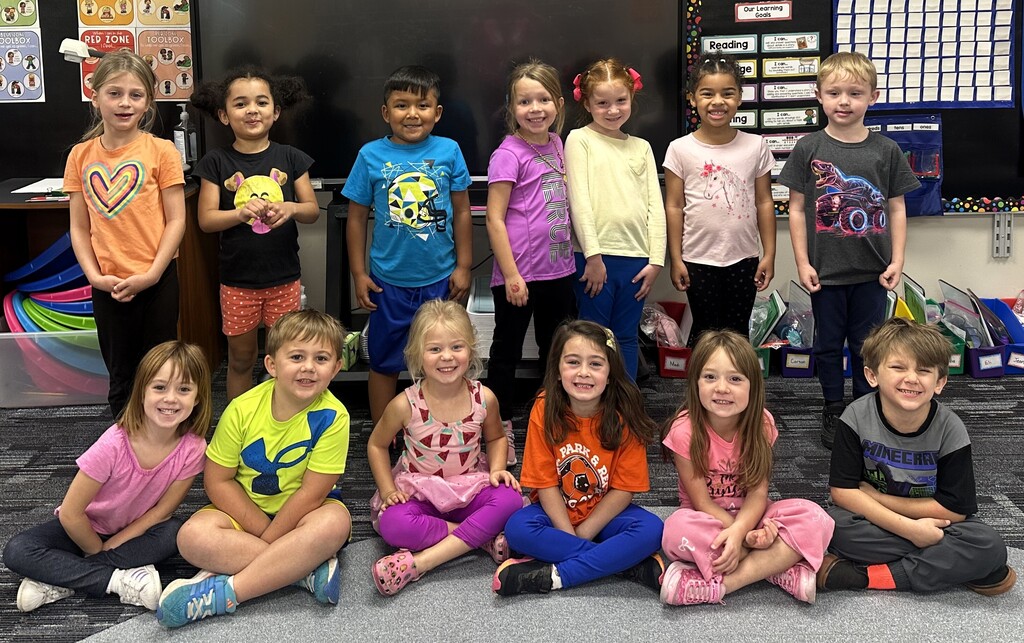 Students smiling while wearing bright neon colors to celebrate Monday's homecoming week dress up day, which was Neon Day.