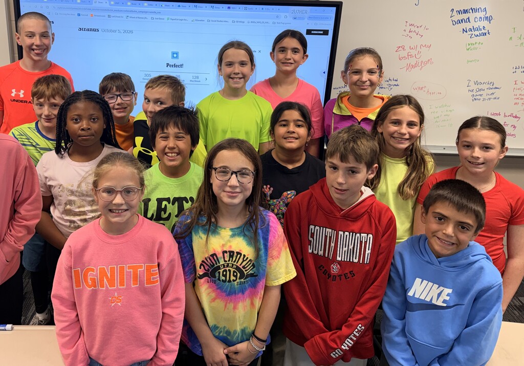 Students smiling while wearing bright neon colors to celebrate Monday's homecoming week dress up day, which was Neon Day.