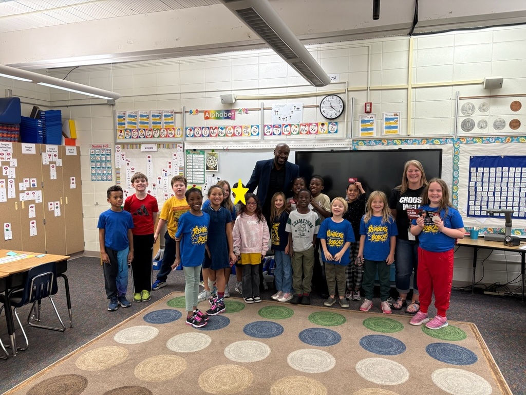 2nd grade students and teacher standing with Mister Brown.