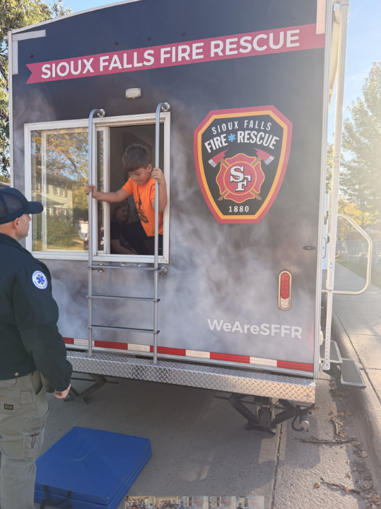 301 student escaping out the window of the SF Fire and Rescue smoke house.